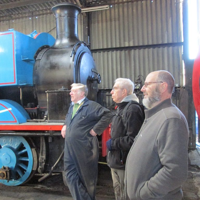 A museum volunteer, Dave Anderson and Neil Byrne enjoying a chat in front of Thomas the Tank Engine.